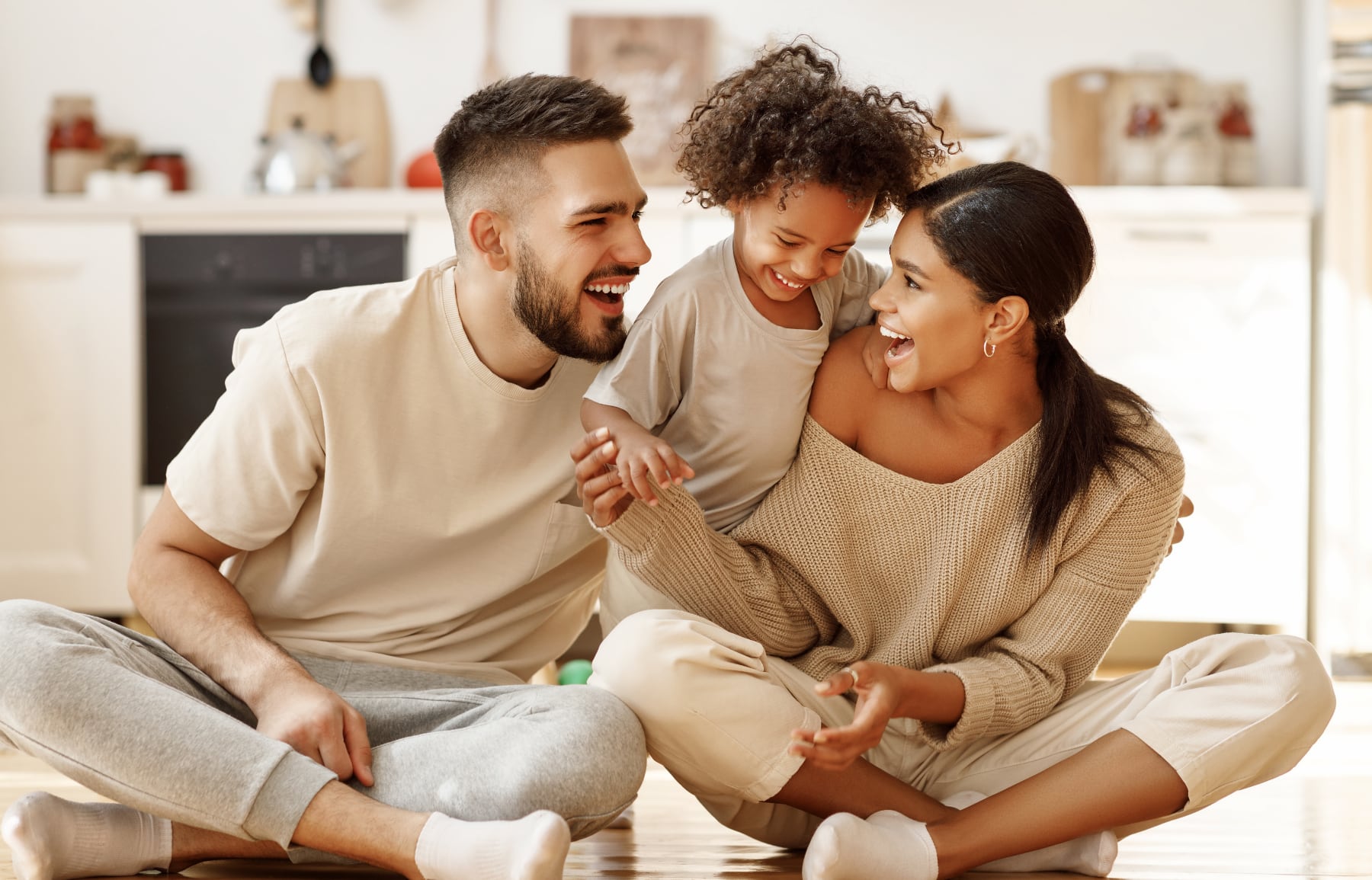 Family sitting on the floor at home.